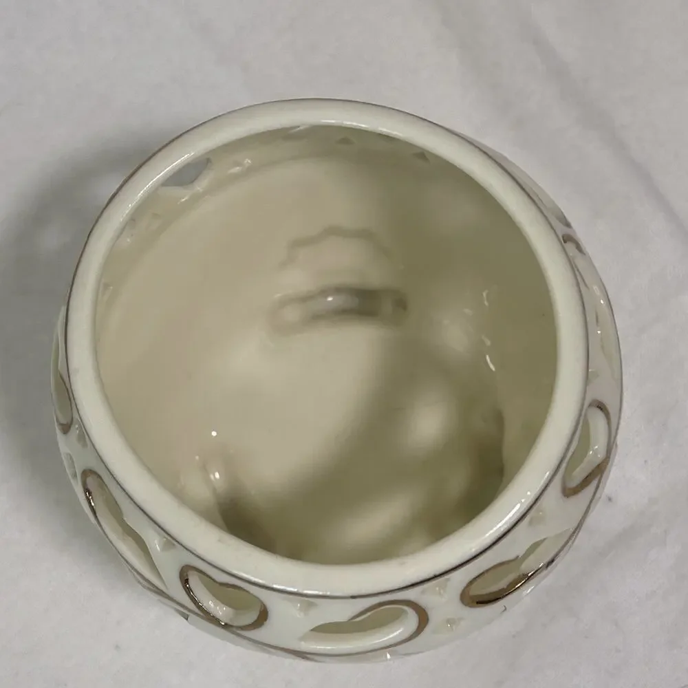 Porcelain Tea Light Holder Cream and Gold Gilding. Three Feet and Cut Outs.